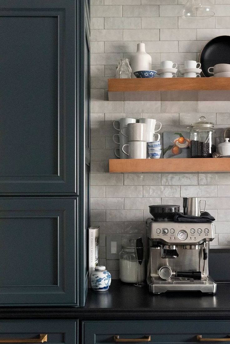 there is a coffee maker on the counter in this kitchen