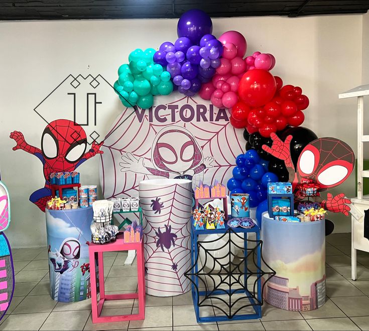 balloons and decorations are on display at a children's birthday party with spiderman theme