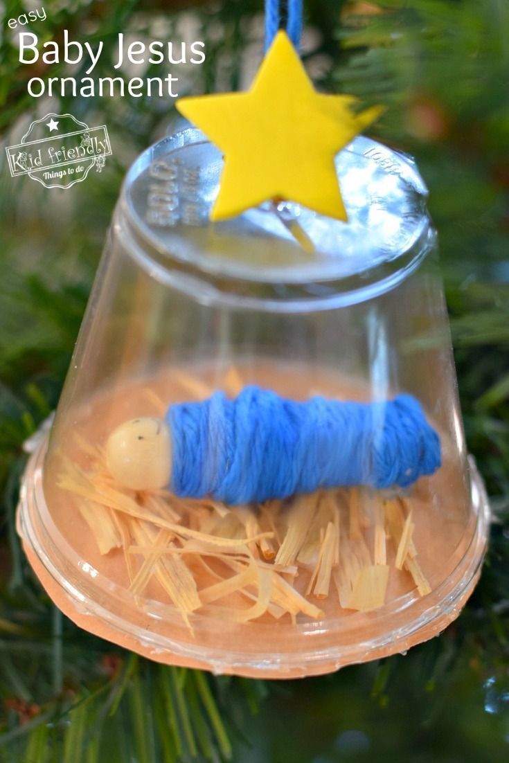 an ornament hanging from a christmas tree with a blue thread wrapped around it