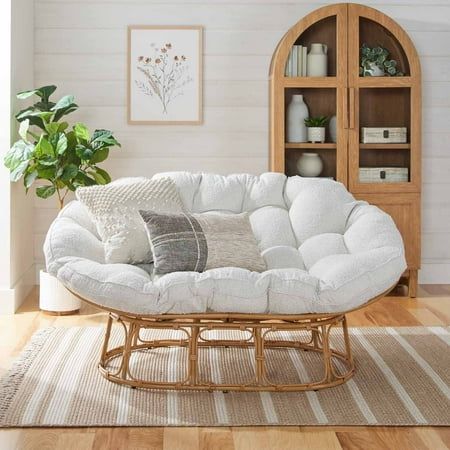 a living room filled with furniture and a white couch in front of a book shelf