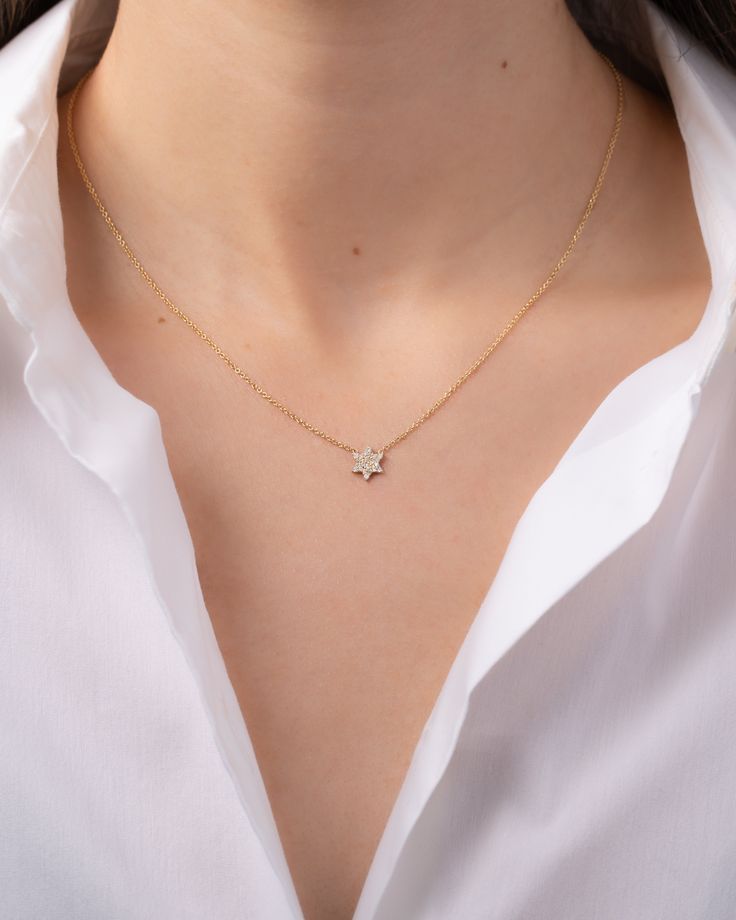 Adorn yourself with elegance in this stunning Star of David necklace, featuring genuine round-cut precious diamonds affixed to a delicate, 14K gold cable link chain. Made in L.A. Size of Star: Approx. 9mm Diamond Carat Weight: Approx. 0.13 ctw Total Weight: Approx. 2.5 grams Ships in 4-8 business days Rush order ships in 3-6 business days Comes gift ready in a beautiful custom jewelry box. Elegant 14k Gold Star Necklace, Elegant Diamond Necklace With Star Of David Charm, Elegant Gold Diamond Necklace With Star Charm, Elegant Diamond White Jewelry With Star Charm, Elegant Star Of David Necklace With Delicate Chain, Elegant Star-shaped Diamond Necklace For Gift, Elegant Star-shaped Diamond Necklace Gift, Elegant Star-shaped Diamond Necklace, Elegant Rose Gold Star Necklace