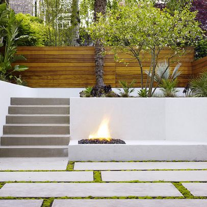 an outdoor fire pit with steps leading up to it