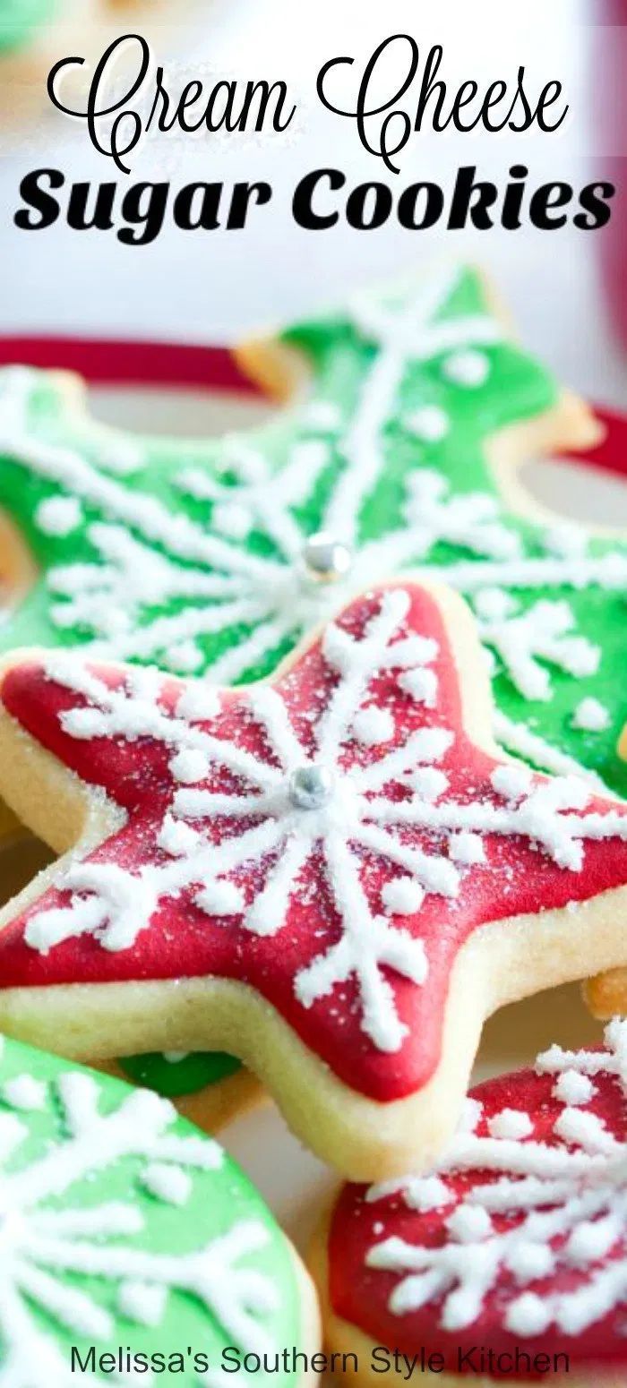 christmas cookies with white and green frosting on them, sitting on a red plate