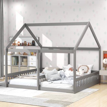 a child's bedroom with a gray bed frame and white pillows on the floor