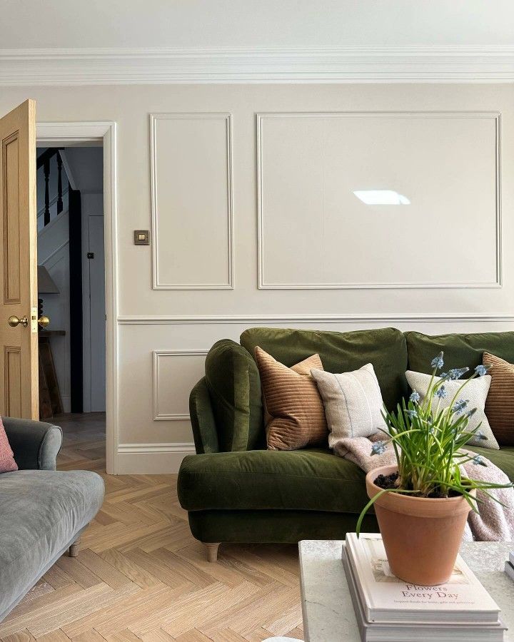 a living room with two couches and a potted plant on the coffee table