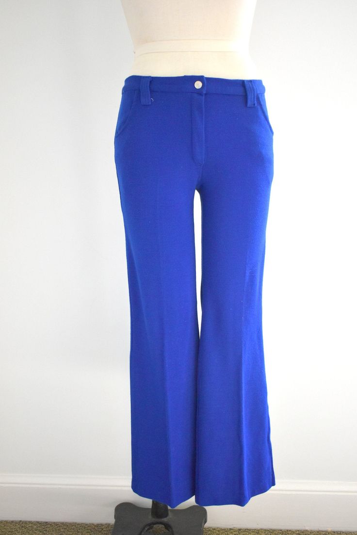 "Description: 1970s bright blue low rise pants. Cotton/polyester knit. Two hip pockets. Snap and nylon zipper closure. Belt loops that can fit a 1.75\" wide belt. Condition: In great condition, with no holes or stains. Designer: Sears Jr. Bazaar Stated Size: 9 Measurements: Waist: up to 30\" (these do not fit the narrowest part of your waist because they are low rise, so take that into account with fit) Hips: up to 36\" Rise: 9.5\" Inseam: 31\" Overall length: 39\" Circumference at hem: 20\" --- Stretch Blue Bottoms With Belt Loops, Retro Blue Bottoms With Pockets, Retro Blue Straight Leg Pants, Retro High Waist Blue Pants, Retro Blue Bottoms With Belt Loops, Retro Blue Full-length Pants, Retro Stretch Blue Pants, Blue Retro Stretch Pants, Retro Blue Stretch Pants