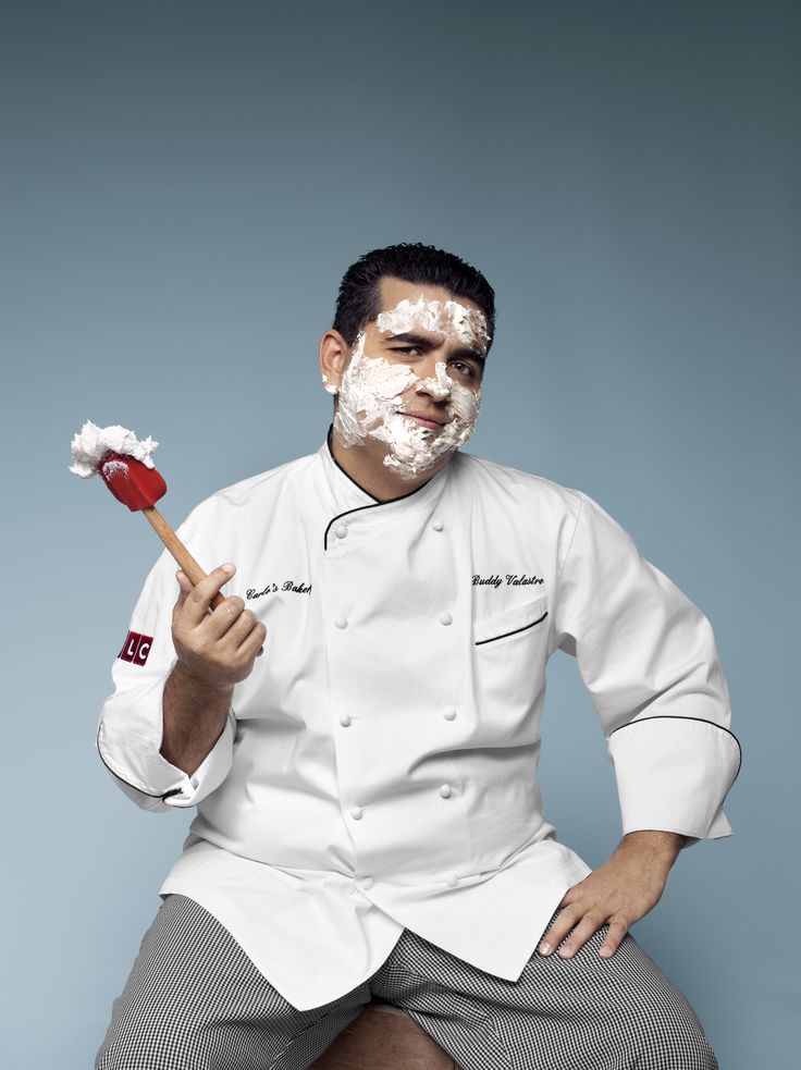 a man in a chef's uniform is holding a spatula