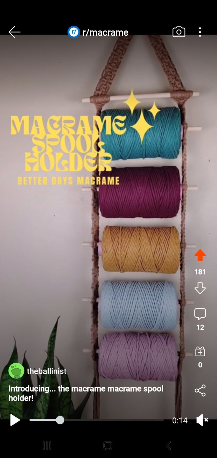 the macrame book and project is displayed on an iphone screen, with multiple spools of thread in front of it