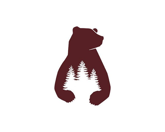 a brown bear with pine trees on it's back