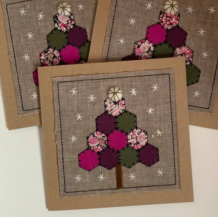 three cards with flowers on them sitting next to each other