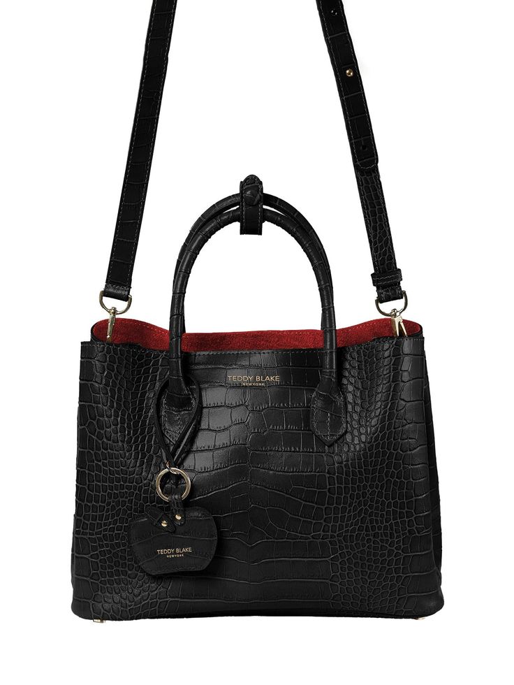 DESIGN Inspired by today's woman, the Vanessa tote's elegant look is handcrafted in strong, scratch resilient croco embossed calf skin. Presenting with a semi-structured silhouette and a roomy interior, it features a median zipper pocket for essentials. Polish every style choice by carrying this new, stylish, light weighted tote by the round elegant handles or attach the leather adjustable shoulder strap. DESCRIPTION  Made In Italy Croco embossed leather with matching trim Real suede interior Gold toned hardware DETAILS  Size Small  11.8"L x 9"H x 6"W Drop length: 4.1" handle Adjustable shoulder strap: min 16.3" max 22.4" Double compartment tote  Median zipper pocket Charm with logo attached  Signature dust bag included Style # 7383 Teddy Blake, Work Tote Bag, Summer Clearance, Gold Interior, How To Make Handbags, Work Bags, Mini Crossbody, Embossed Leather, Bag Sale