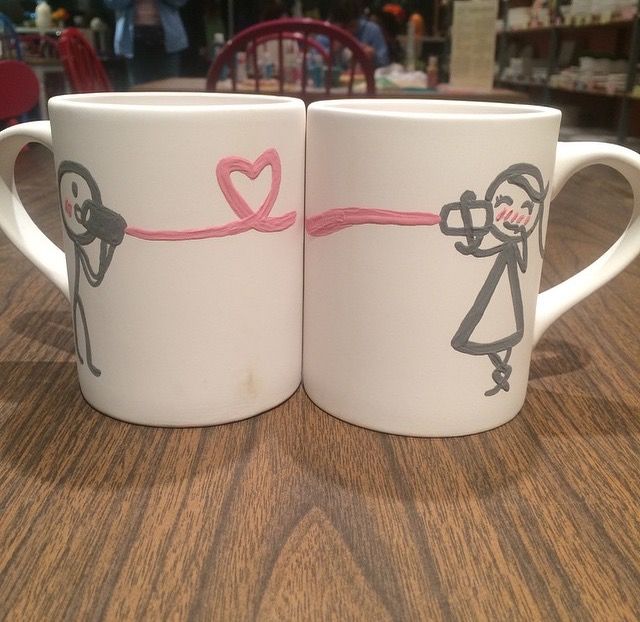 two coffee mugs with stick figures on them