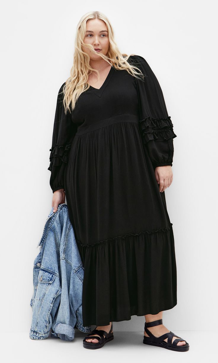 Impress them all with the Malia Plain Maxi Dress. The V neckline adds a classic yet flattering touch to your look. Complete with a relaxed tiered skirt and long sleeves, take your styling to new heights with this dress. Key Features Include: - V neckline - Long sleeves w/elastic cuff - Side invisible zip closure - Functional side pockets - Partially lined - Relaxed tiered skirt - Maxi length Pair with embellished heels for date night. | Plus Size Malia Plain Maxi Dress in Black, Size 16 | City C Date Night Plus Size, Plain Maxi Dress, Dresses Date Night, Embellished Heels, Skirt Maxi, Plus Size Maxi, Lingerie Dress, Date Night Dresses, Invisible Zip