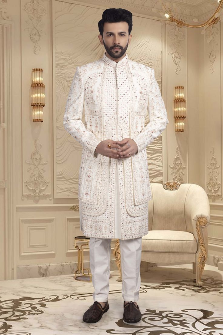 This Mens Sherwani features a layered design. Expertly crafted for grooms, Features stunning red accents to add a touch of traditional elegance to your special day. Exude confidence and style as you walk down the aisle in this expertly designed sherwani. Mens Sherwani, Walk Down The Aisle, Exude Confidence, Layered Design, Walking Down The Aisle, Red Accents, Your Special, Layers Design, Special Day