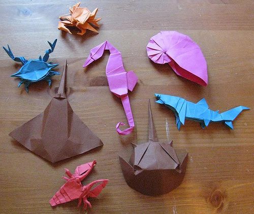 origami fish and umbrellas on a wooden table