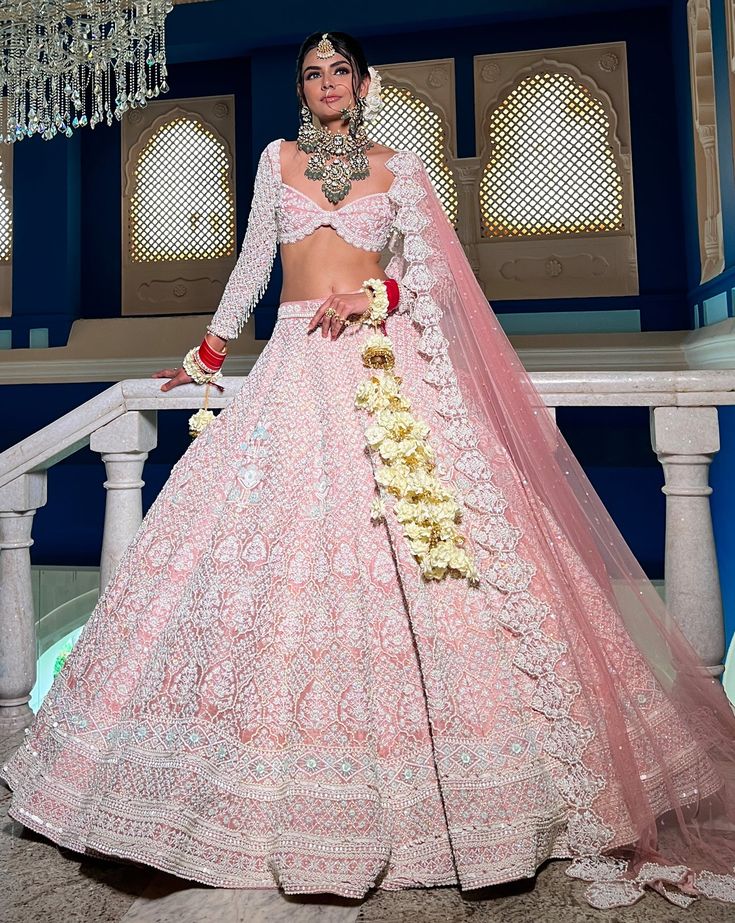 Reverie Bridal set is a stunning coral pink lehenga hand embroidered on pure raw silk fabric with signature glass crystals, pearls, sequins, and beads and has scalloped edges on the lehenga. It's paired with an attractive hand-embroidered blouse with cap sleeves on net fabric. It comes with a peachy pink soft net scall Pink Hand Embellished Lehenga For Festivals, Traditional Pink Hand Embellished Choli, Pastel Lehenga, Raw Silk Lehenga, Latest Bridal Lehenga, Beautiful Veil, Lehenga Designs Simple, Raw Silk Fabric, Traditional Indian Dress