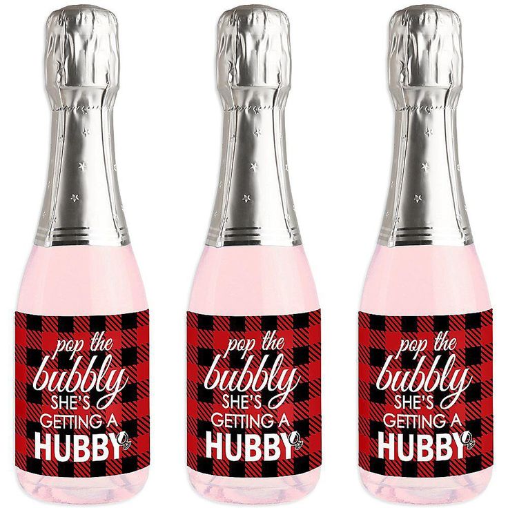 three bottles of pink liquid with red and black plaid designs on them, one is empty