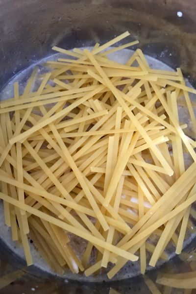 pasta is being cooked in a pot on the stove