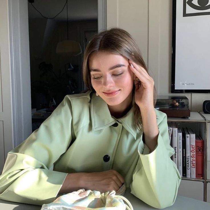 a woman sitting at a table in front of a cake