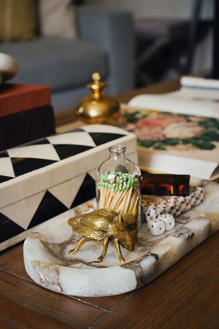 the table is covered with decorative items such as candles and trinkets in glass bottles