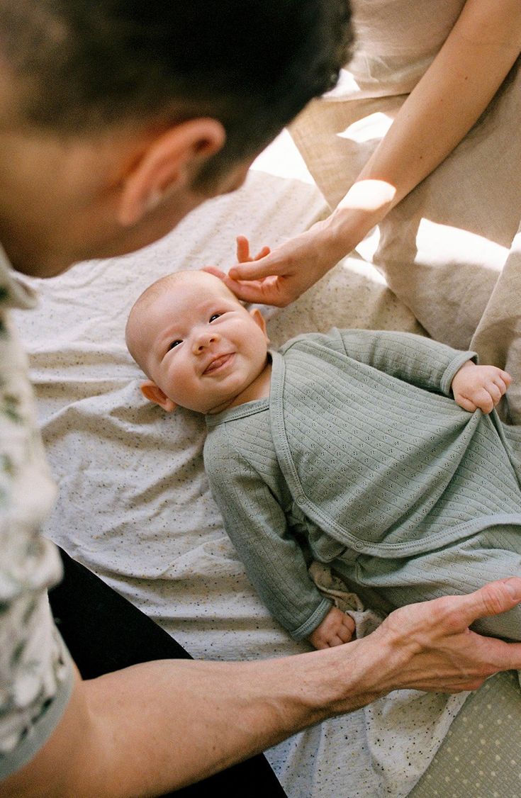 Newborn boy smiles up at his dad during a newborn photoshoot in Auckland, New Zealand. New Baby Family Photos At Home, In House Newborn Pictures, Film Newborn Photography, Newborn Film Photography, Newborn Studio Family Photos, Newborn Documentary Photography, Cozy Newborn Family Photos, Newborn Pics At Home, In Home Newborn Session Lifestyle