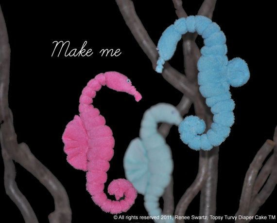 two seahorses made out of yarn sitting on top of tree branches with the words make me written above them