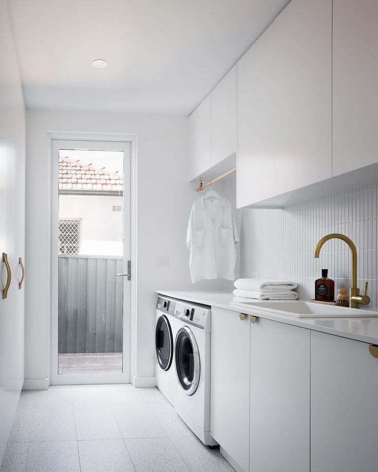 a washer and dryer in a white laundry room