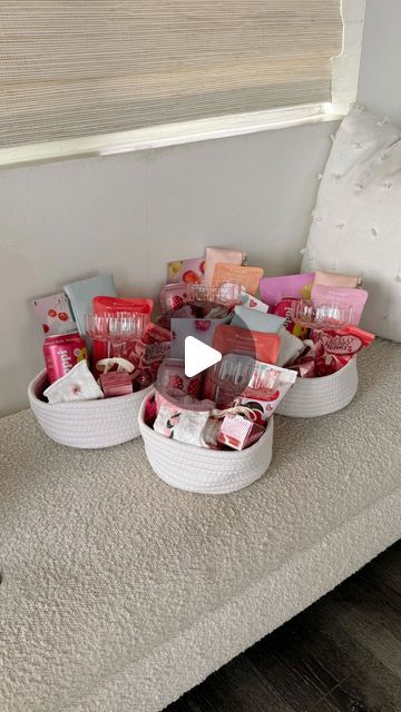 two baskets filled with different types of items on top of a white table next to a window