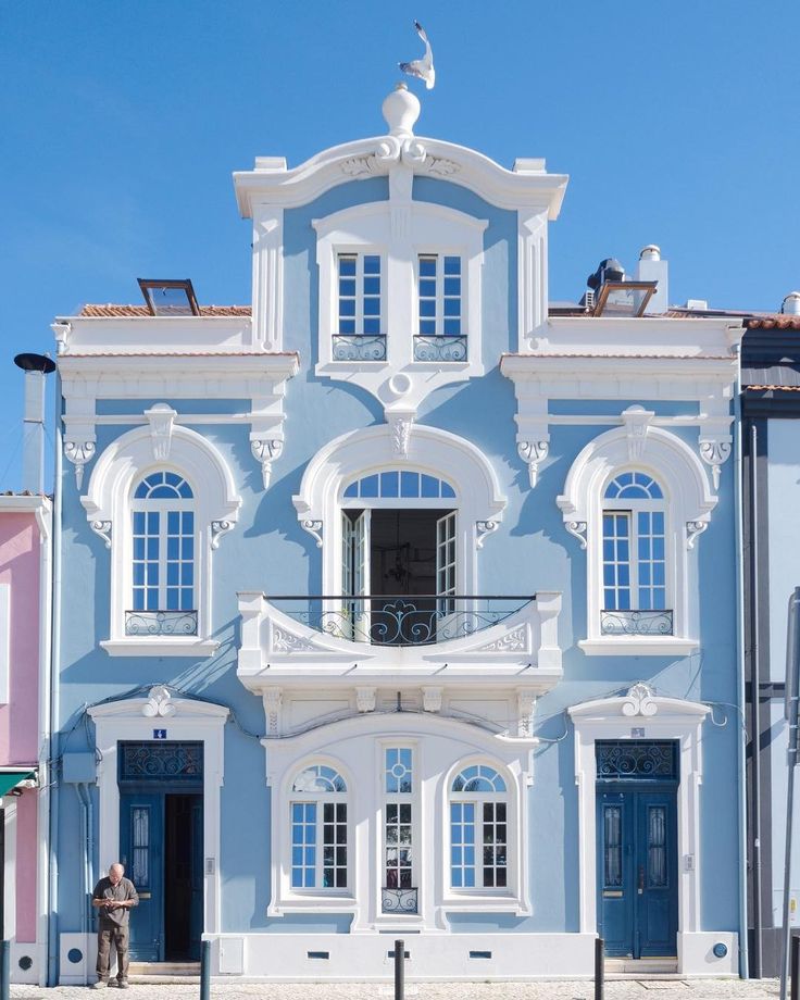 a large blue and white building on the street