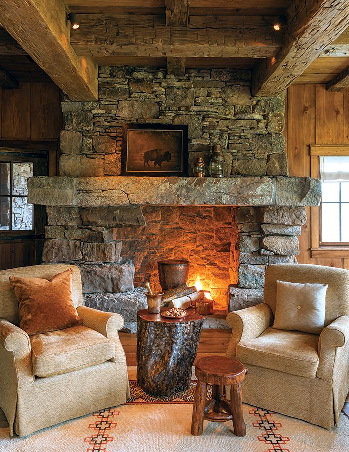 a living room with two chairs and a fire place