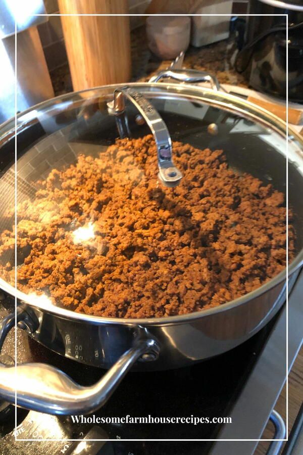 a pan filled with food sitting on top of a stove next to a burner