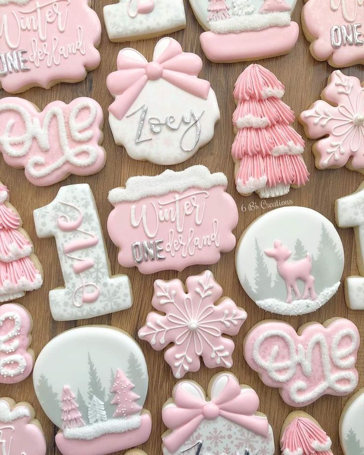 pink and white decorated christmas cookies on a table