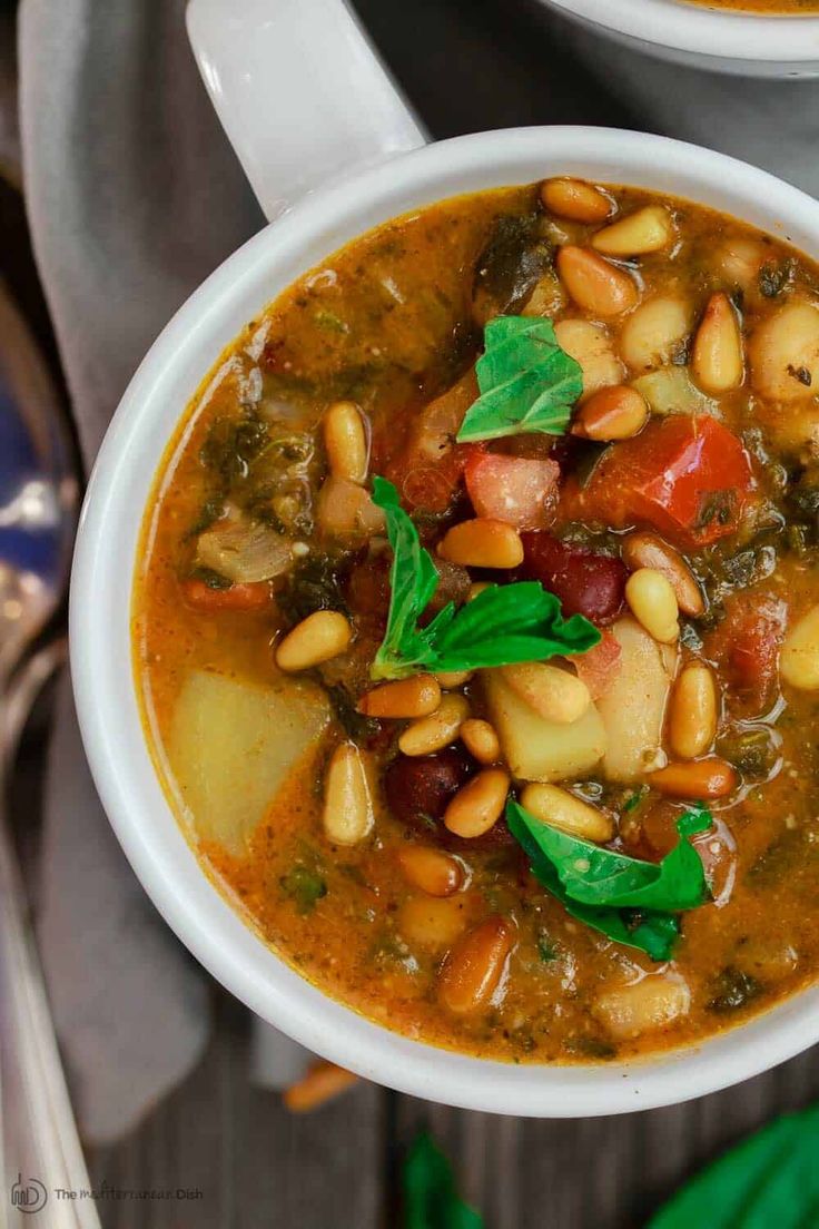 a white bowl filled with soup and beans