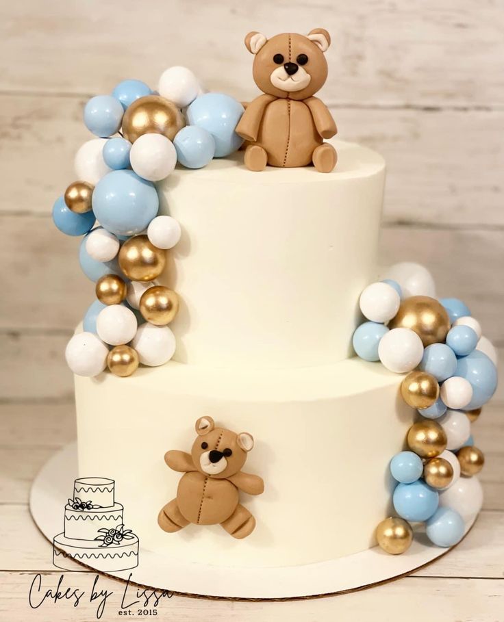 a three tiered cake with two teddy bears on top and balloons around the bottom