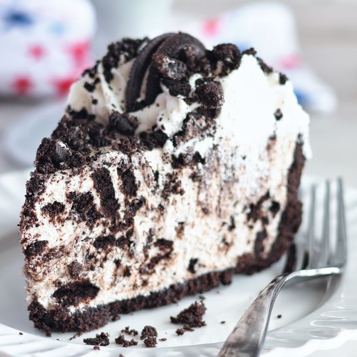 a piece of oreo cake on a plate with a fork