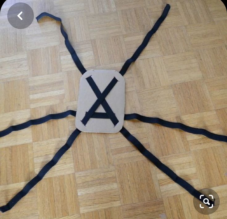 a spider made out of cardboard on the floor