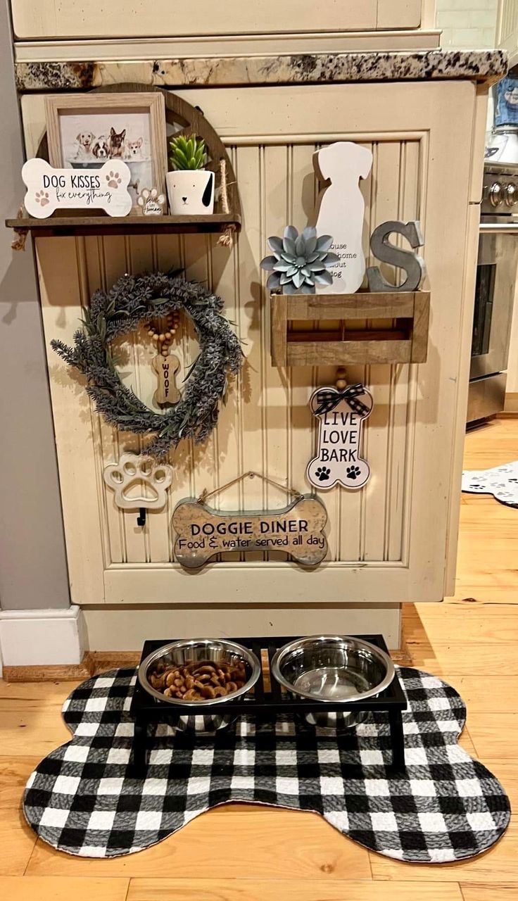 two dogs are eating food out of their bowls on the kitchen floor in front of an old cabinet