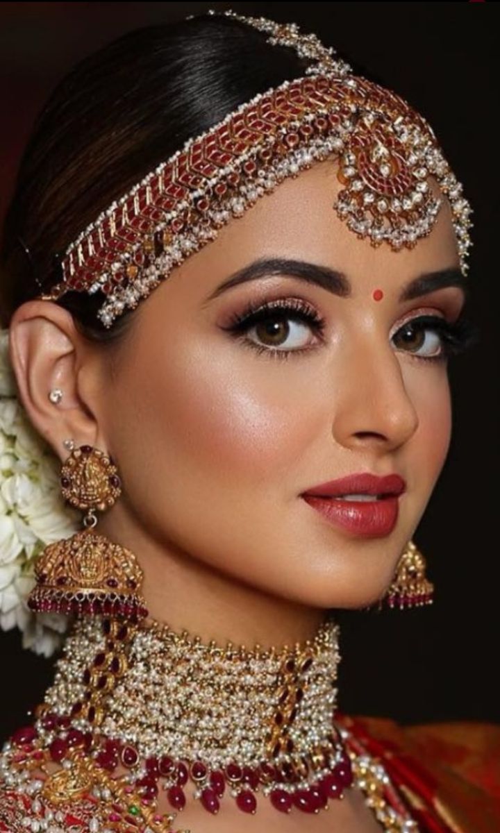 a woman wearing an elaborate headpiece and jewelry