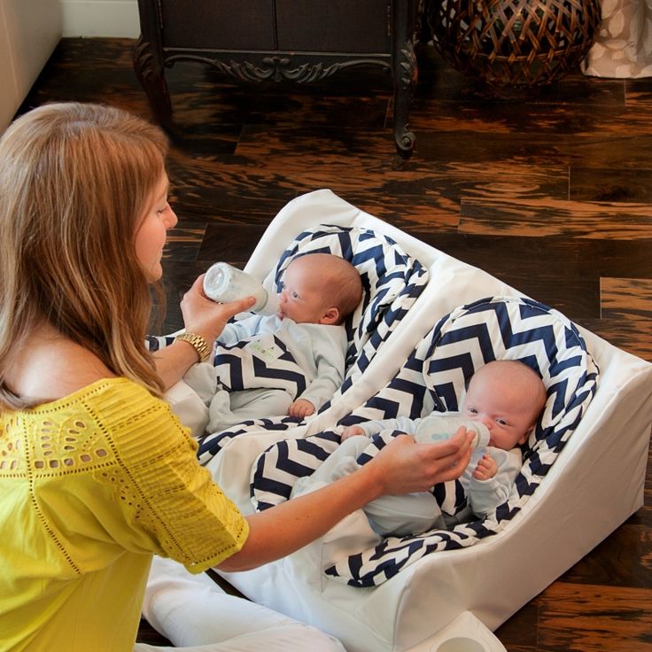 a woman is holding a baby and feeding it