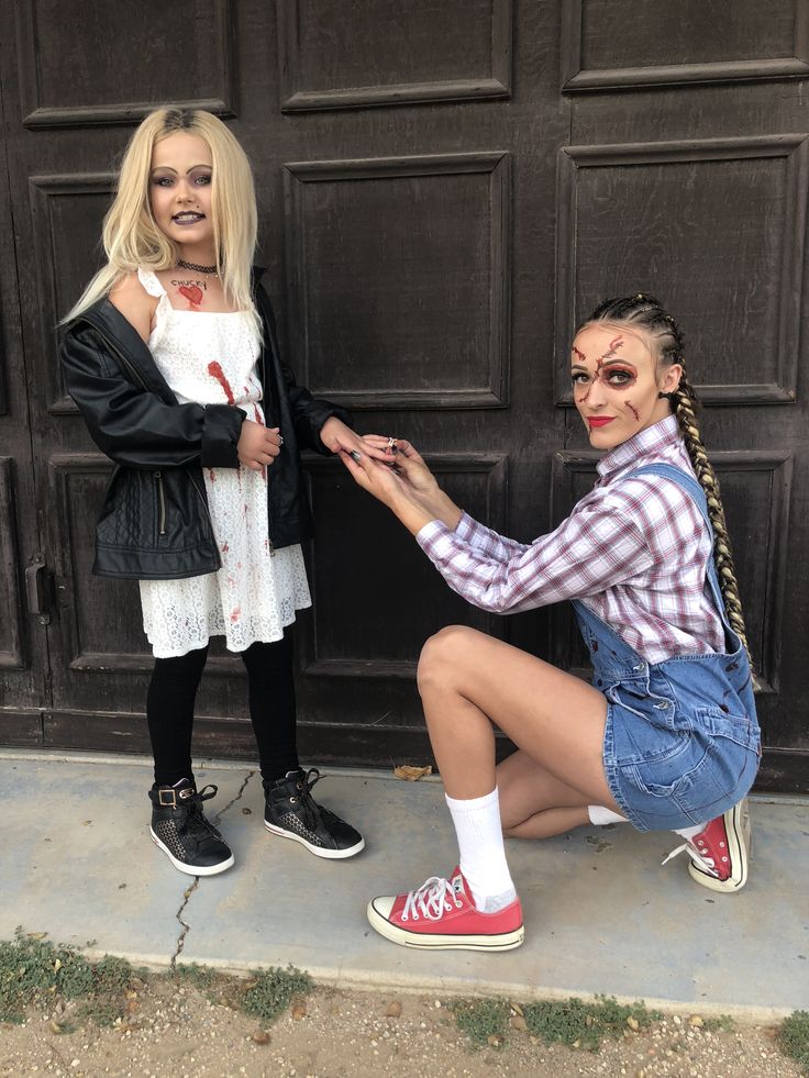 two women dressed up in costumes posing for the camera