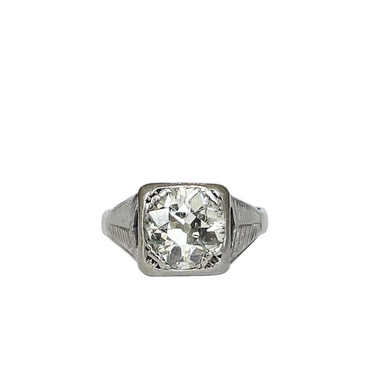 an old cut diamond ring on a white background