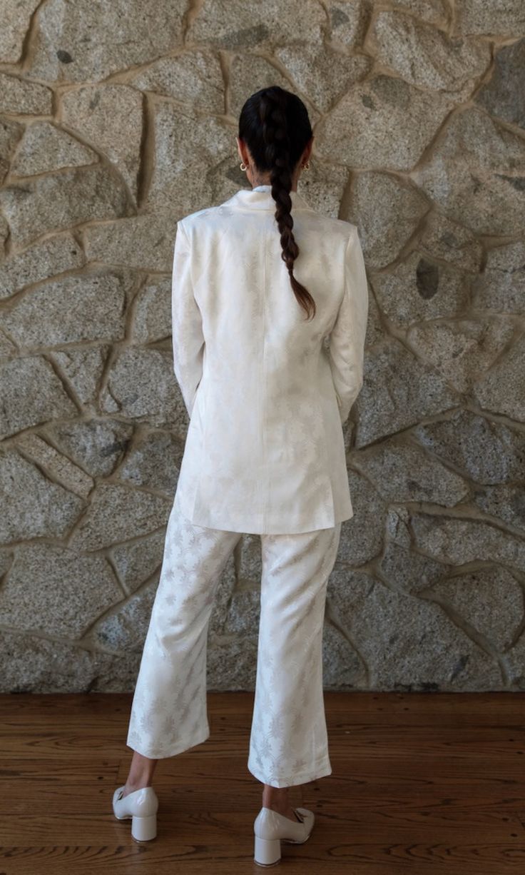 SILK BROCADE BRIDAL SUIT JACKET AND PANTS. IVORY SATIN LINER. PANT CAN BE ORDERED CROPPED OR FULL LENGTH. *POCKET SQUARE, VEST, NECK TIE, OR ASCOT ALL AVAILABLE TO ORDER SEPARATELY. DOS PIECES SIMILAR TO THIS BRIDAL PANT SUIT: IF YOU’RE LOOKING FOR A FLORAL JACQUARD BRIDAL SUIT CHECK OUT OUR "MARGAUX" SUIT BY CLICKING ON THE LINK ASSOCIATED. Elegant Silk Wedding Pants, Tailored Notch Lapel Blazer For Ceremonies, Elegant Cream Pantsuit For Formal Occasions, White Silk Blazer For Wedding, Chic Silk Blazer For Wedding, White Silk Wedding Blazer, Spring Silk Formal Pantsuit, Elegant Long Sleeve Three-piece Suit For Spring, Tailored Single Breasted Wedding Pantsuit