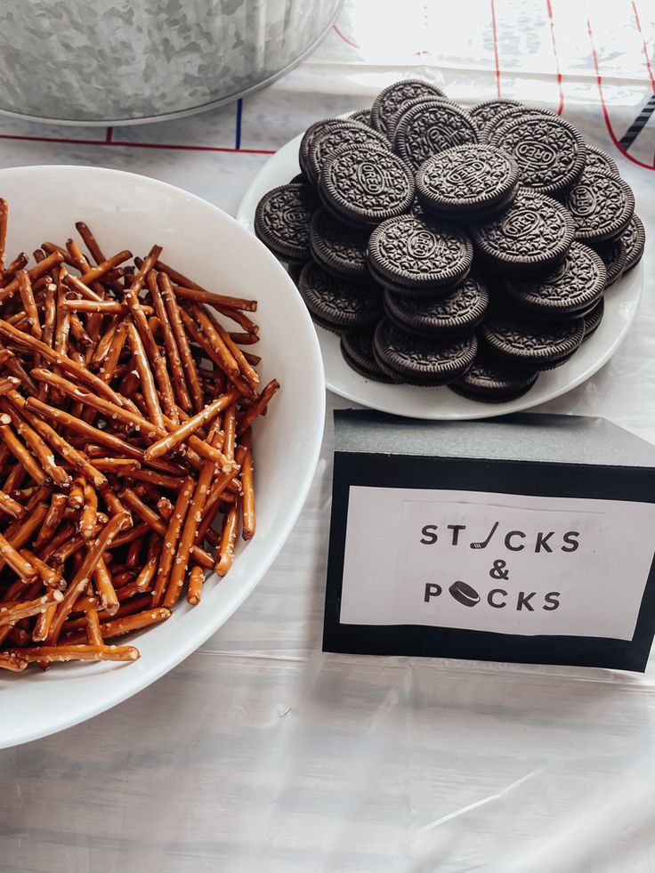 there are cookies and crackers in the bowl on the table next to each other