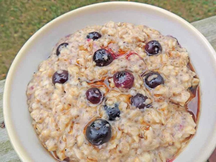 a bowl of oatmeal with blueberries and raisins in it