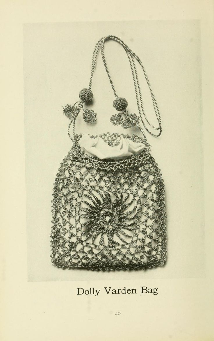 an old photo of a crocheted bag with pom poms on it