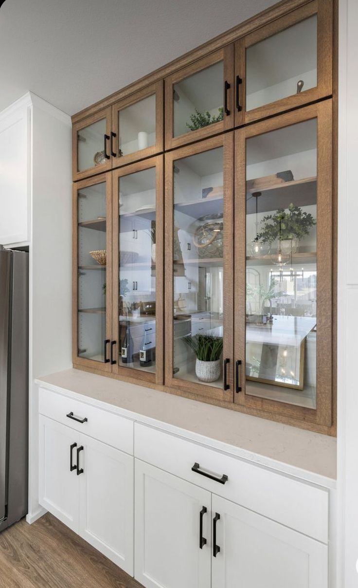 a kitchen with wooden cabinets and white cupboards