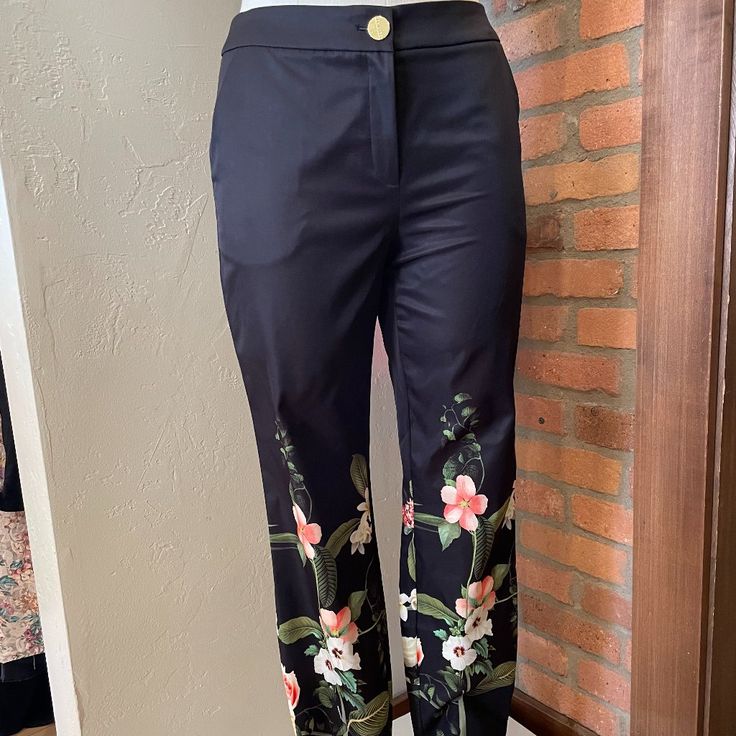 Ted Baker Black Pants With Skinny Ankle. Floral Pattern Print With Dainty Gold Ankle Zipper. Size 1 (Us 4) Nwt. Fabric: 100% Polyester Length: 35 Inches Elegant High-waisted Floral Print Pants, Elegant Floral Print High-waisted Pants, Elegant High-waisted Floral Pants, Elegant High Waist Floral Print Bottoms, Elegant Fitted Floral Print Pants, Elegant Floral Print Pants For Workwear, Elegant Floral Print Workwear Pants, Elegant Floral Print Work Pants, High Waist Floral Print Work Pants