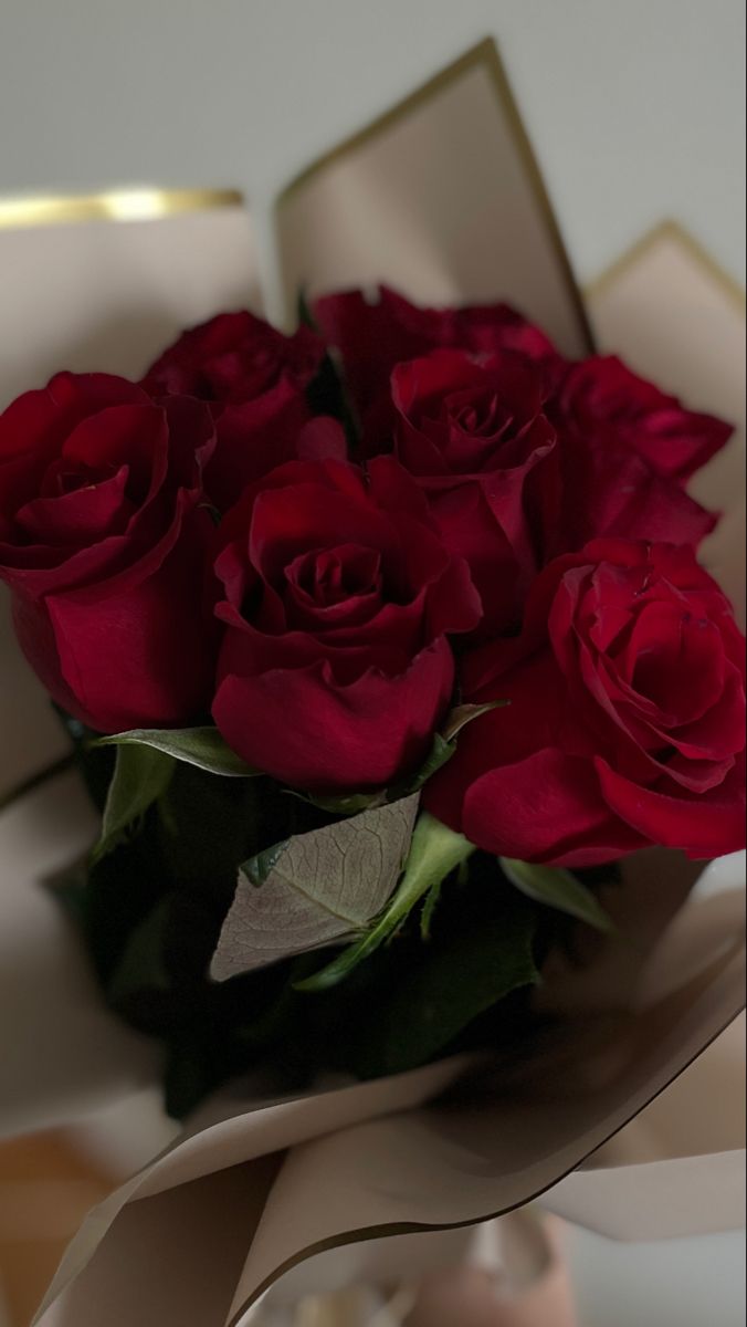 a bouquet of red roses in a box