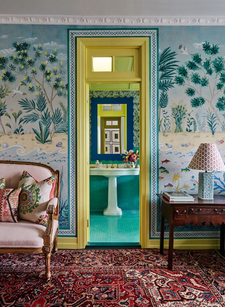 a living room with colorful wallpaper and rugs on the floor next to a table