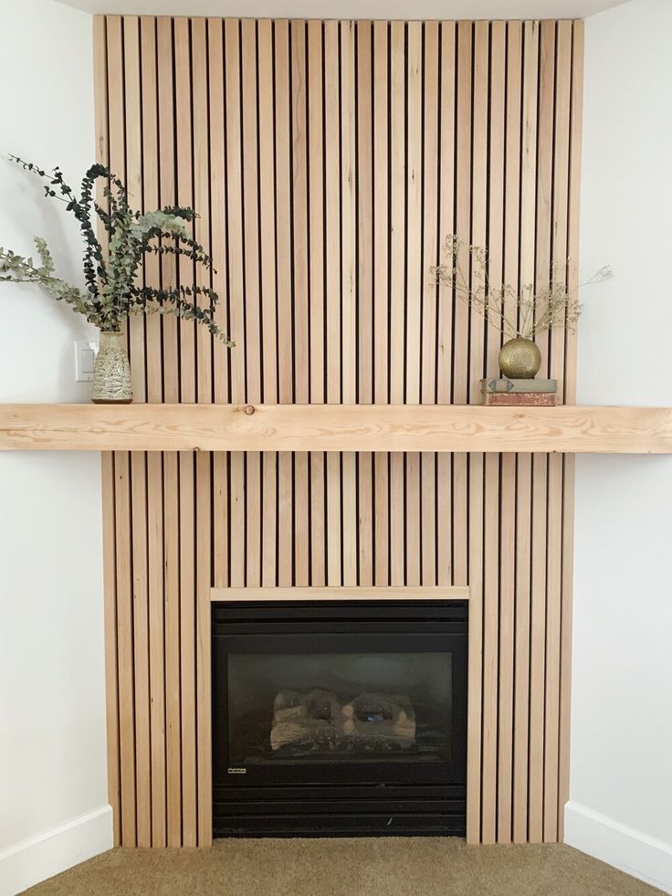 there is a fireplace in the living room with wood paneling on the wall behind it